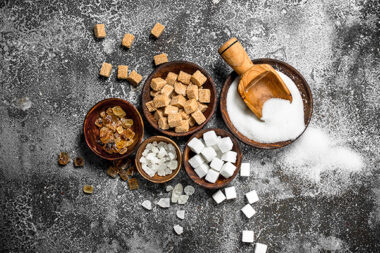 Different kinds of sugar in bowls.