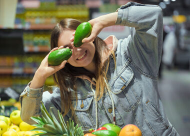 Young woman with fruit in her hands in the supermarket .